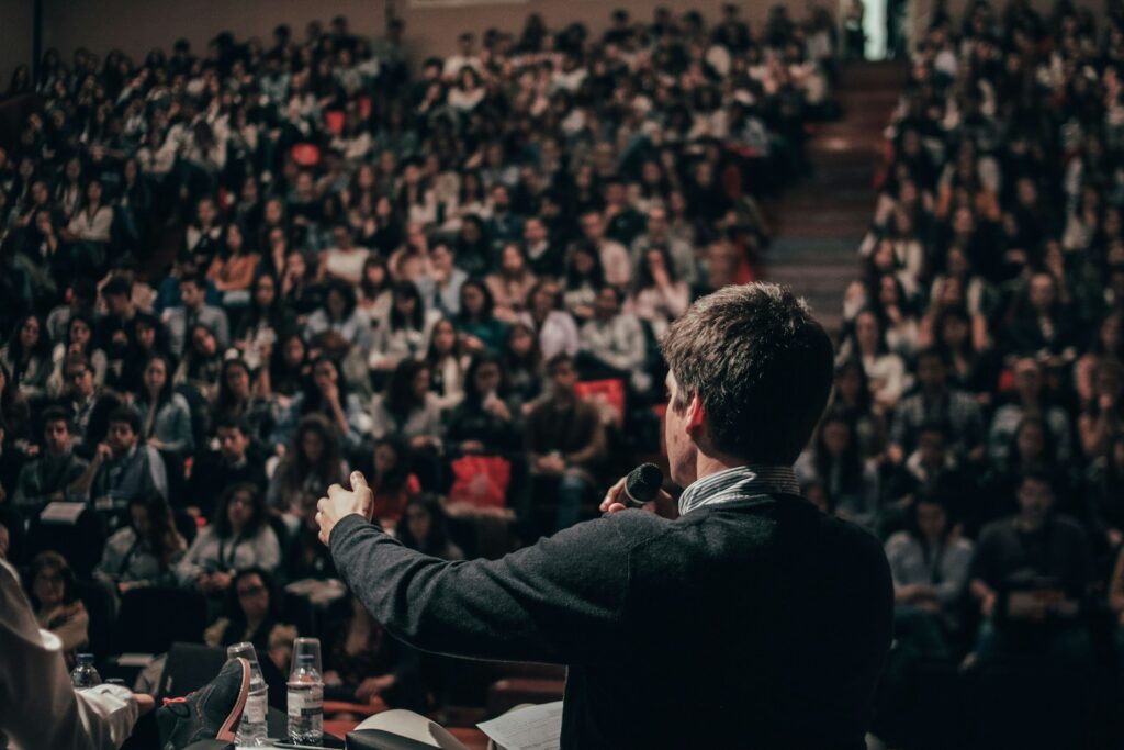 A business leader addressing a packed audience
