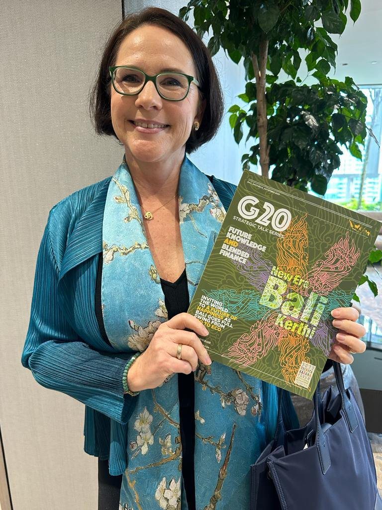Luxembourg Minister Yuriko Backes holding the Group of Nations G20 Bali edition
